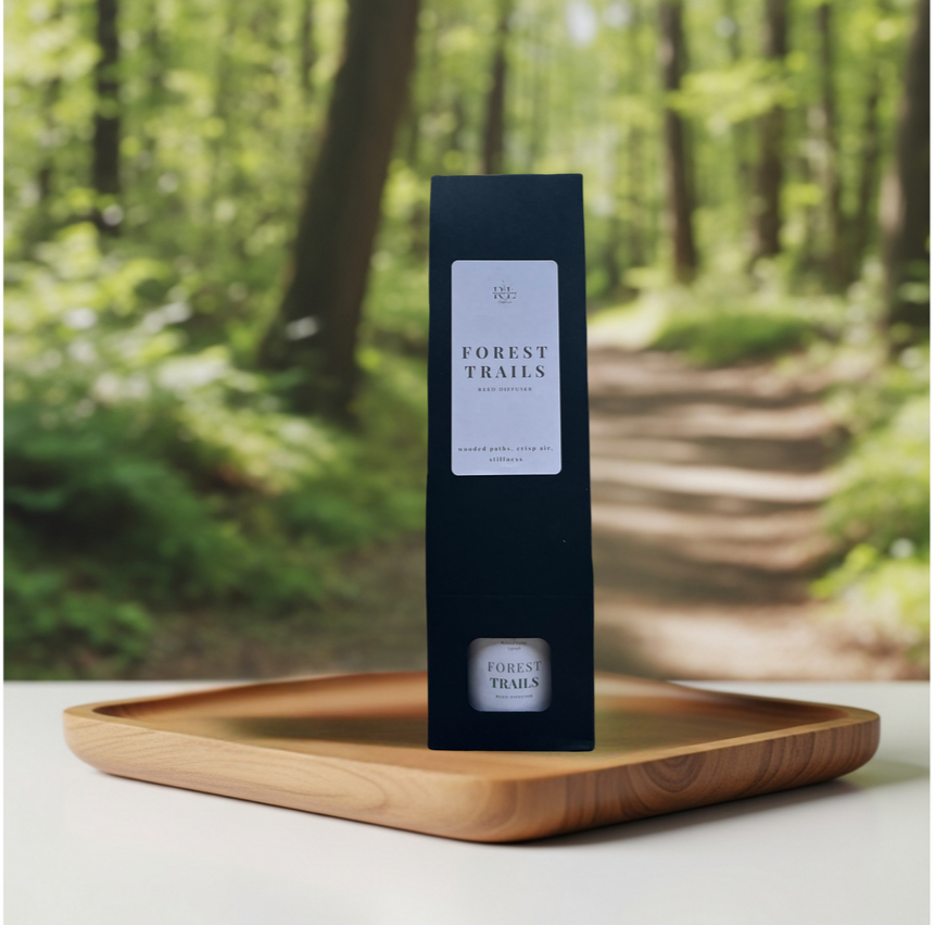 Forest Trails reed diffuser displayed in a luxe gift box on a tray, inspired by quiet forest paths with notes of pine, cedar, sage, and balsam