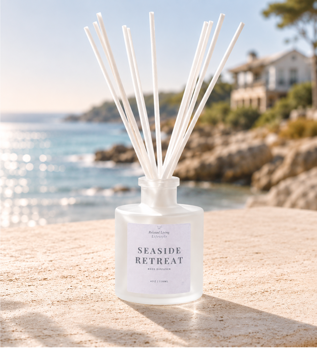 Seaside Retreat reed diffuser displayed on a textured surface in a coastal-inspired room with a blurred ocean view through a window in the background.