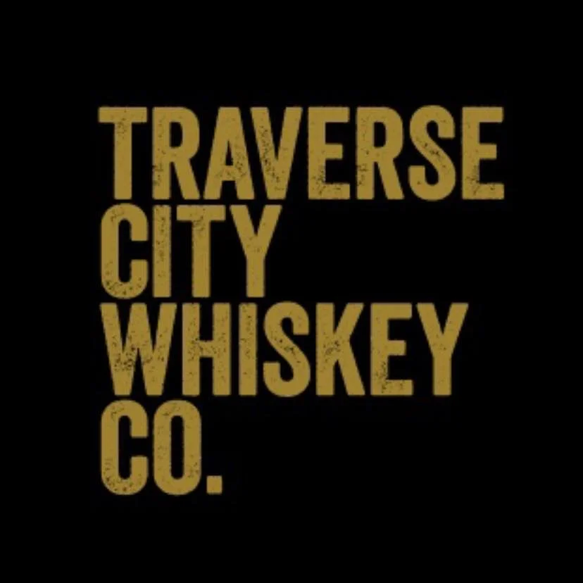 Text on a black background reads "Traverse City Whiskey Co." in gold lettering.