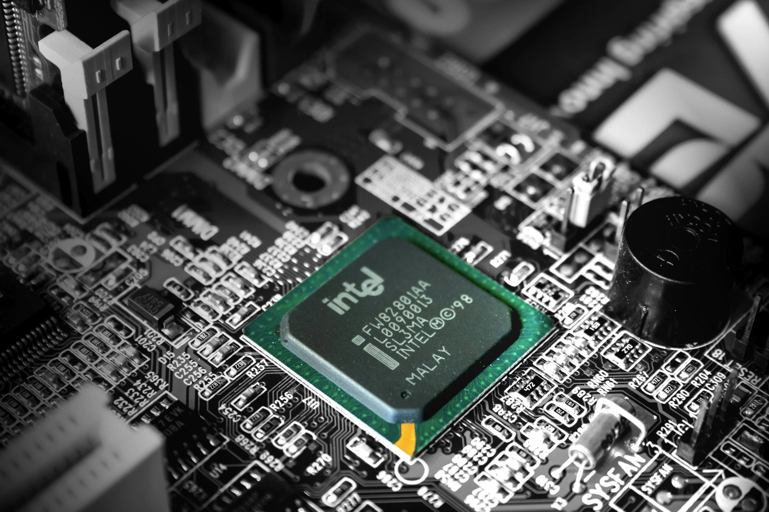 Close-up of a computer motherboard with an Intel processor installed in the center.