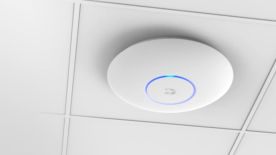 Ceiling-mounted speaker with a blue ring light.