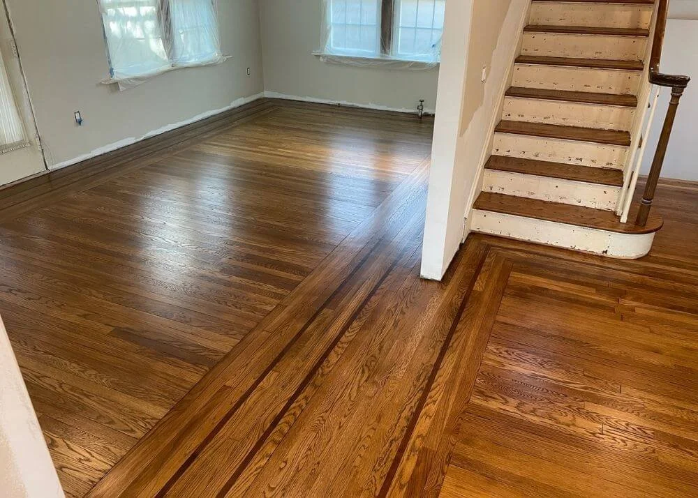 Custom stained hardwood floors Grafton Massachusetts with double dark border inlay.