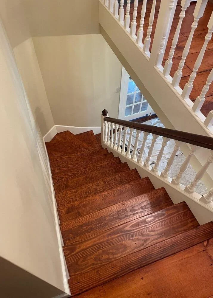 A staircase and hallway red oak floor installation Grafton Massachusetts home.