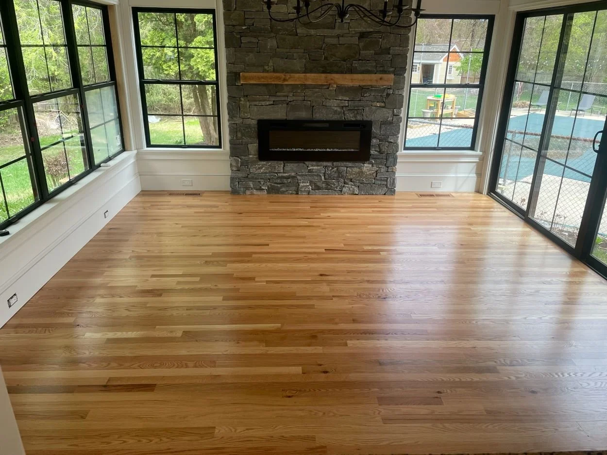 LIVING-ROOM-WITH-STONE-FIREPLACE-AND NEWLY-INSTALLED-HARDWOOD-FLOORS-.JPG