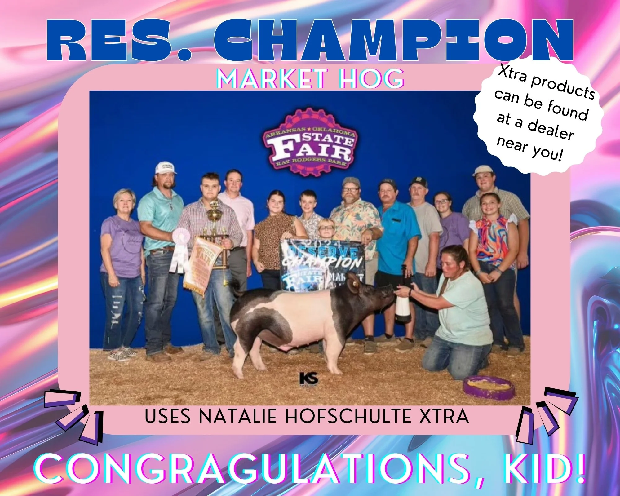 A group of people celebrating with a pig at the Arkansas State Fair, with a blue backdrop. Text overlays include "RES. CHAMPION MARKET HOG," "CONGRATULATIONS, KID!" and a speech bubble saying "Xtra products can be found at a dealer near you!"