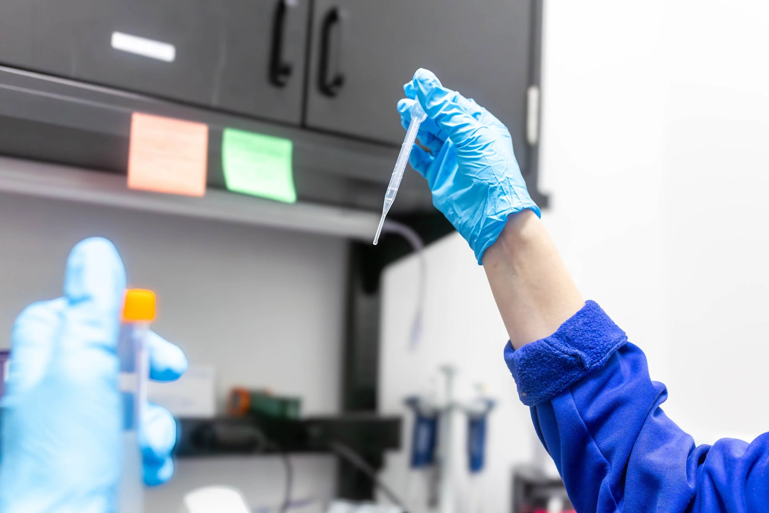 ViaGen laboratory scientist handling pipette and test tubes professional content photography taken by Be Better MediaWorks Oklahoma marketing and content creation agency