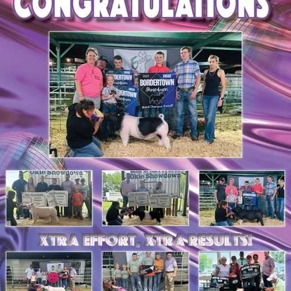 Group of people at a fair showing a pig winning a contest, with awards and banners displayed.