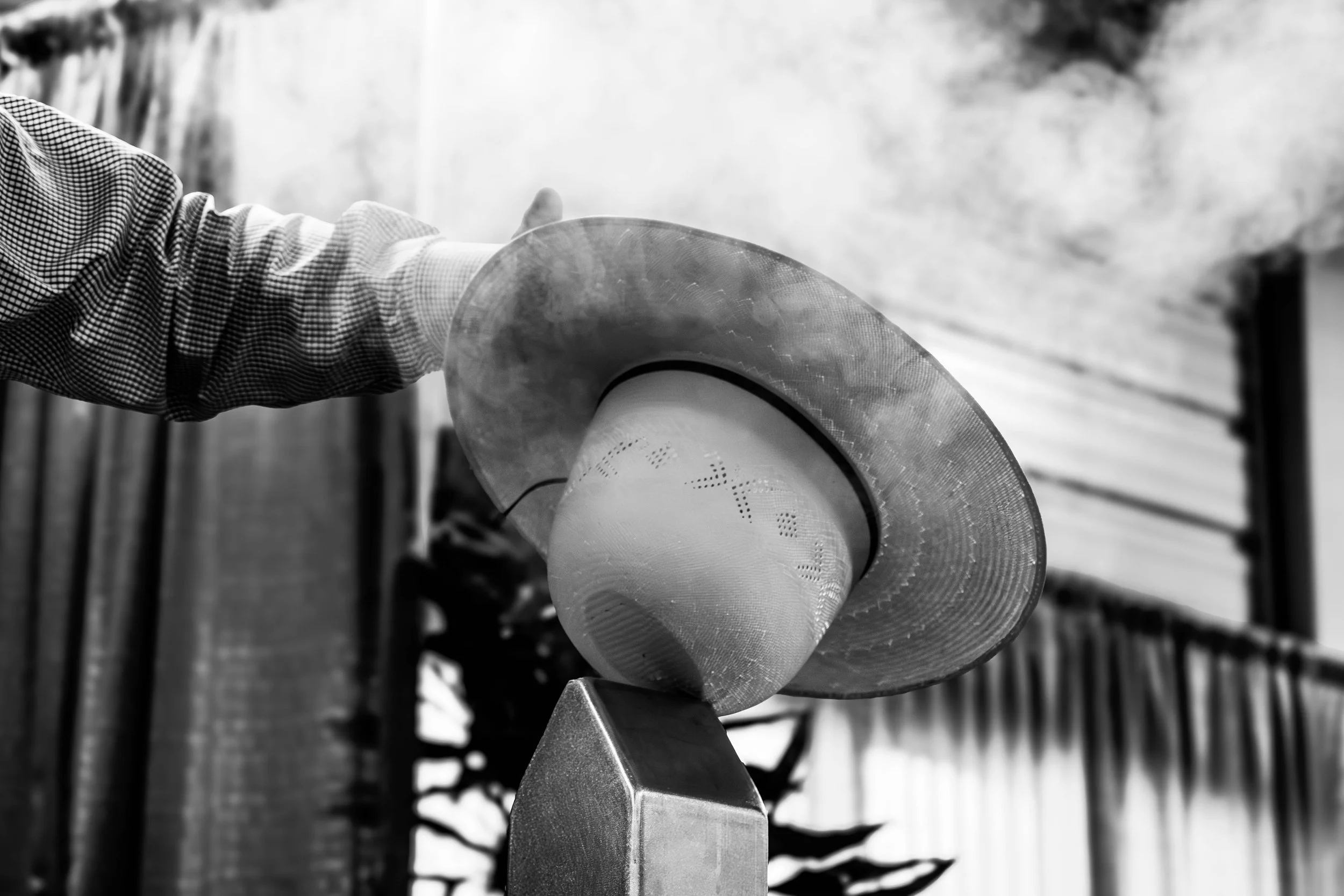 Hat and boot company wide brim hat lifestyle product photography black and white taken by Be Better MediaWorks Oklahoma marketing and content creation agency.