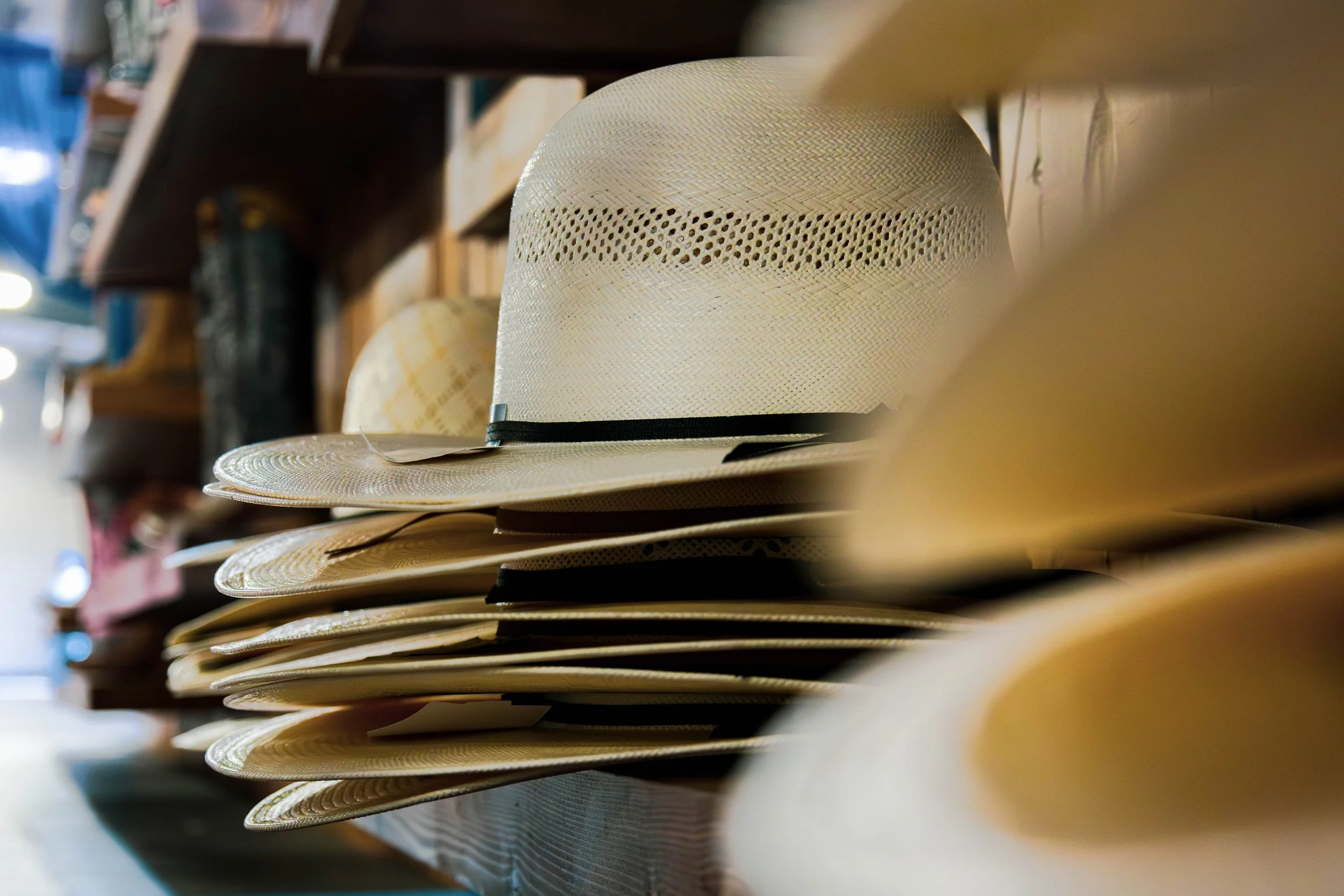Stacked straw hats retail store product photography taken by Be Better MediaWorks Oklahoma marketing and content creation agency.