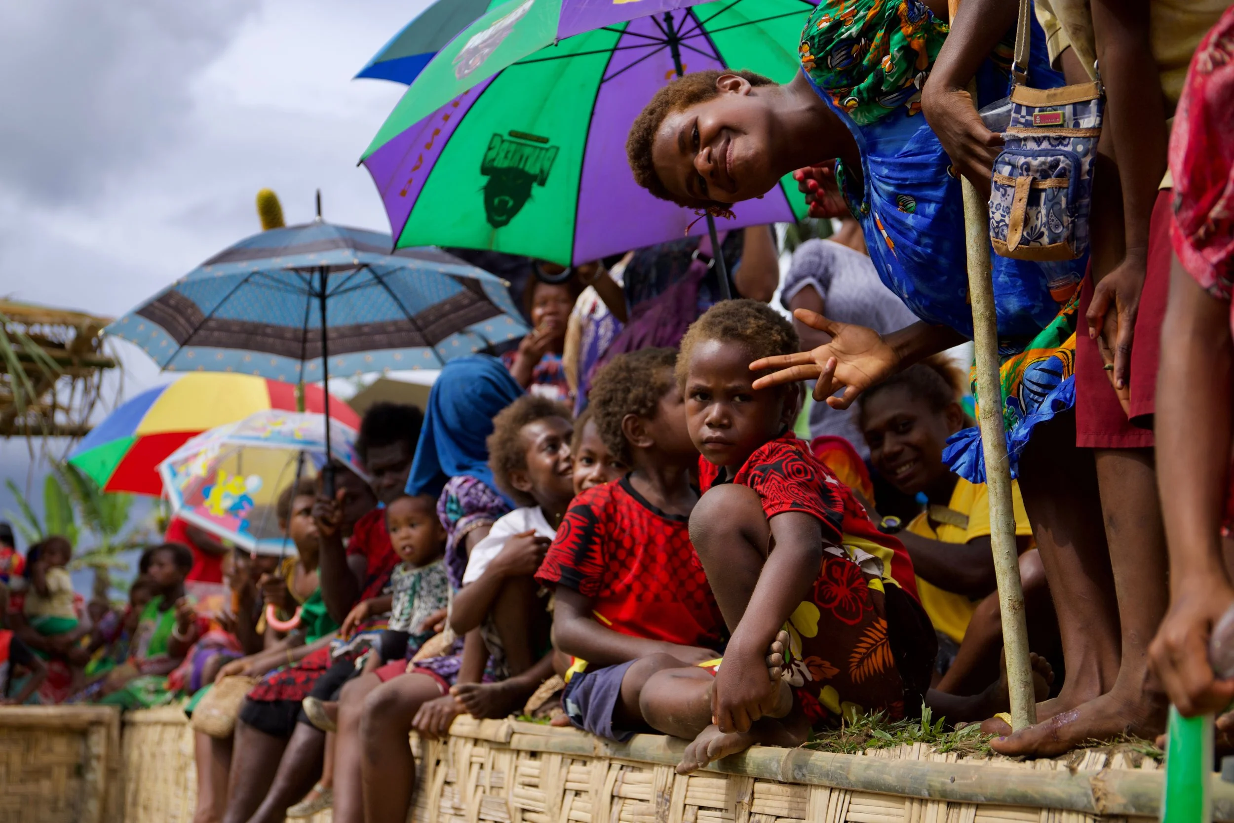 Portraits and candid moments of Papua New Guinea’s diverse cultures, featuring traditional dress, masks, and ceremonial performances.