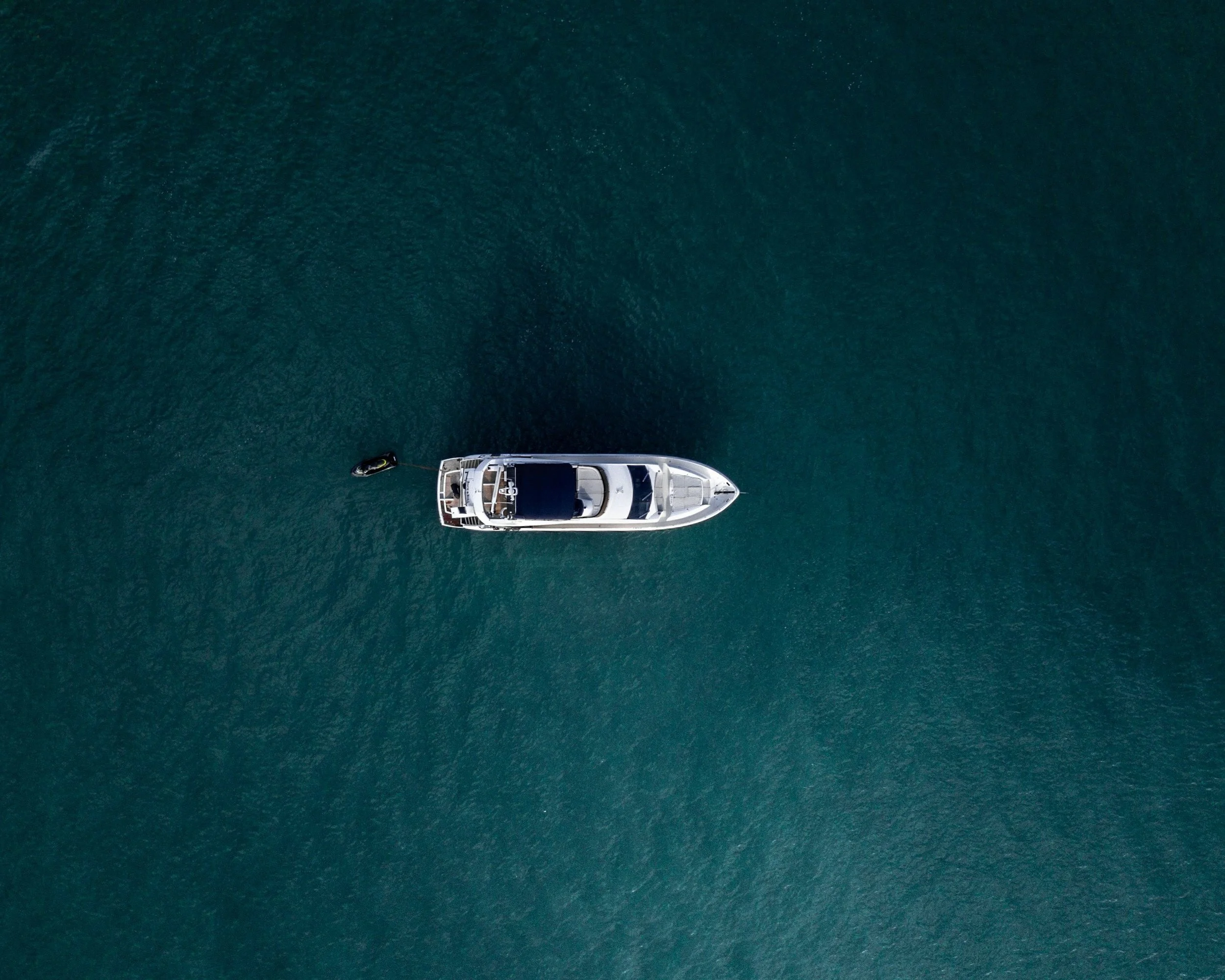 Top-down view of a luxury yacht floating in tranquil open water off Papua New Guinea, perfect for private island-hopping and exclusive marine adventures.