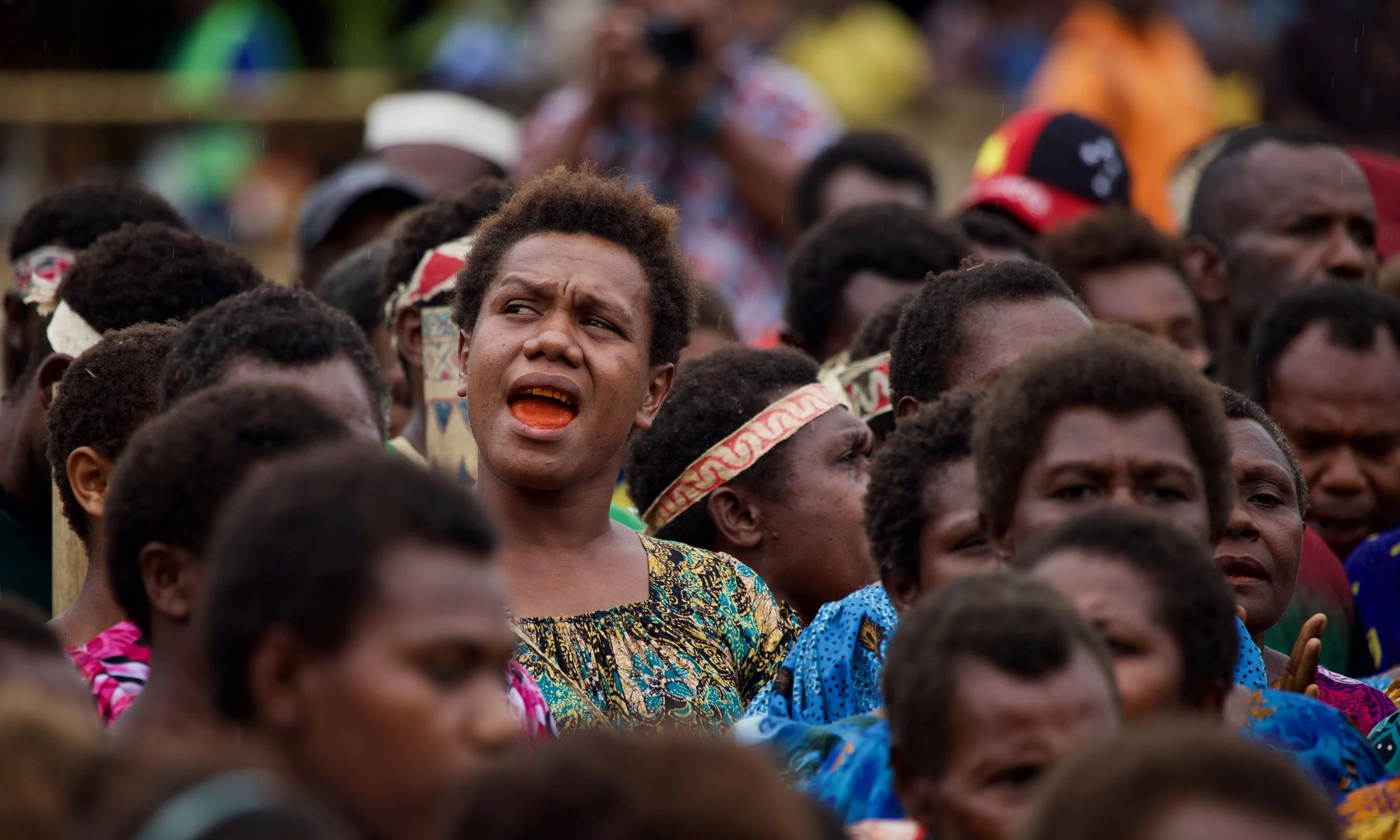 Portraits and candid moments of Papua New Guinea’s diverse cultures, featuring traditional dress, masks, and ceremonial performances.