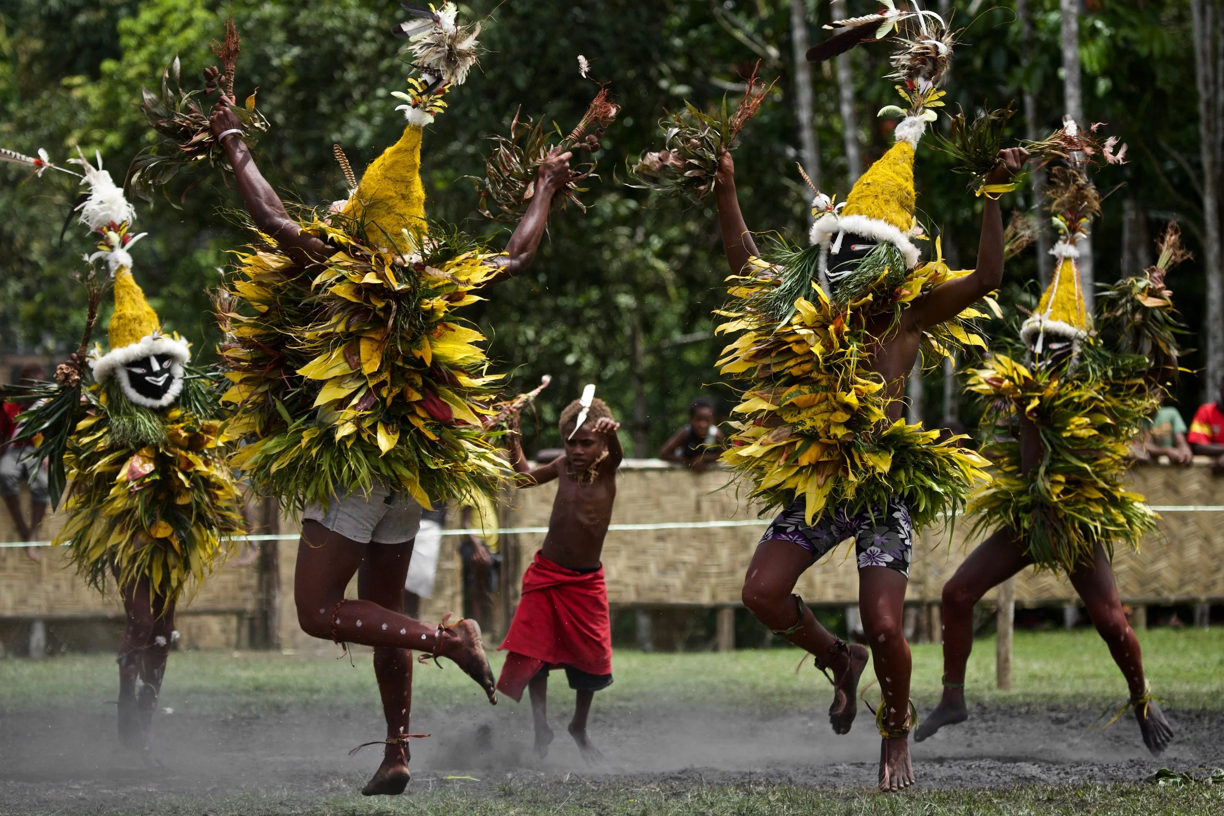 Portraits and candid moments of Papua New Guinea’s diverse cultures, featuring traditional dress, masks, and ceremonial performances.