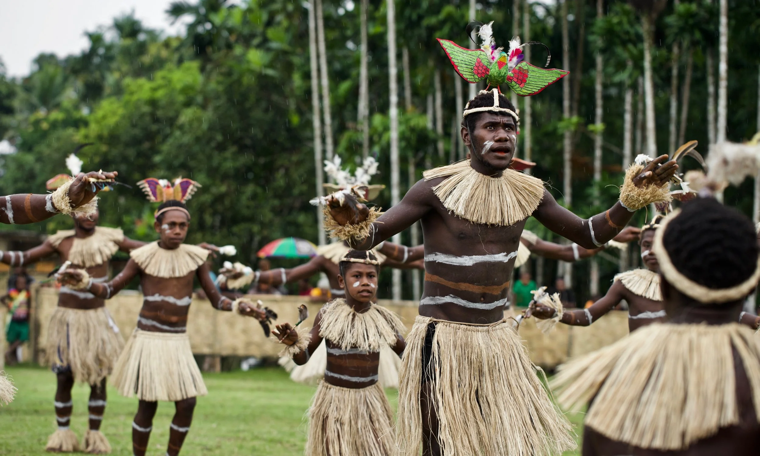 Portraits and candid moments of Papua New Guinea’s diverse cultures, featuring traditional dress, masks, and ceremonial performances.
