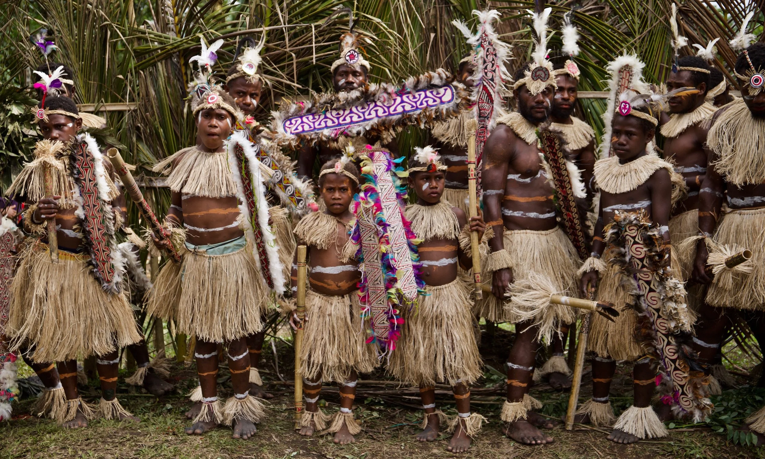 Portraits and candid moments of Papua New Guinea’s diverse cultures, featuring traditional dress, masks, and ceremonial performances.