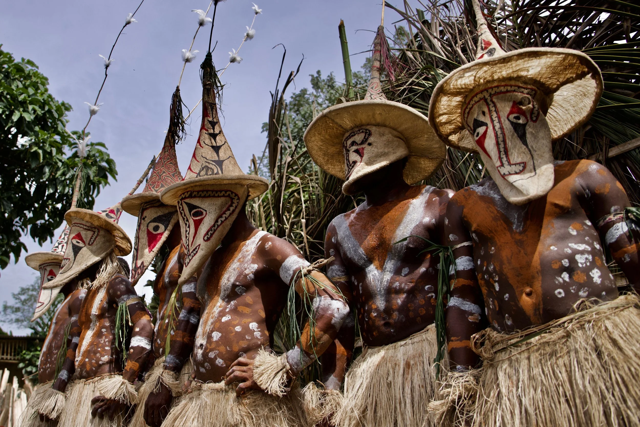 Portraits and candid moments of Papua New Guinea’s diverse cultures, featuring traditional dress, masks, and ceremonial performances.