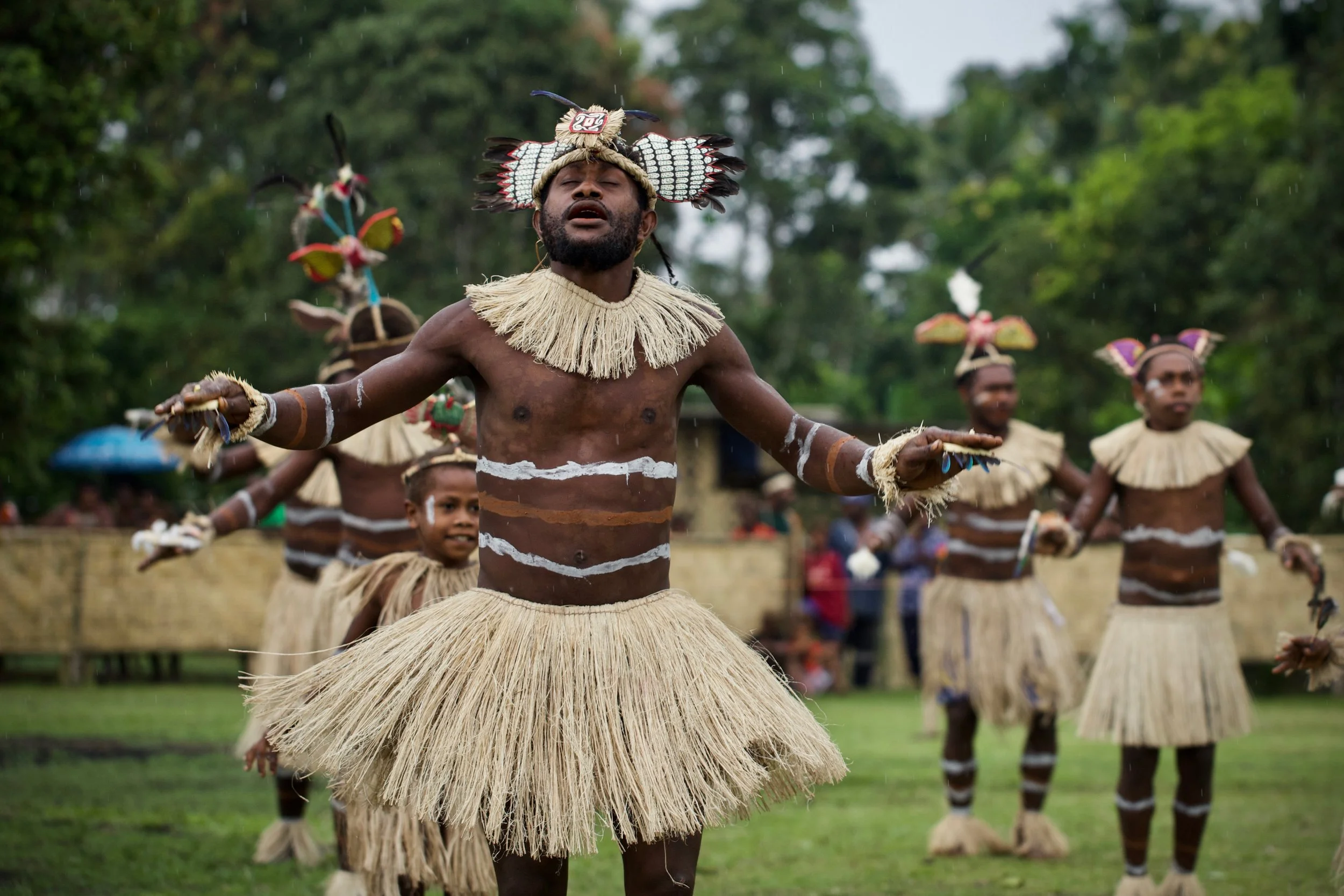 Portraits and candid moments of Papua New Guinea’s diverse cultures, featuring traditional dress, masks, and ceremonial performances.
