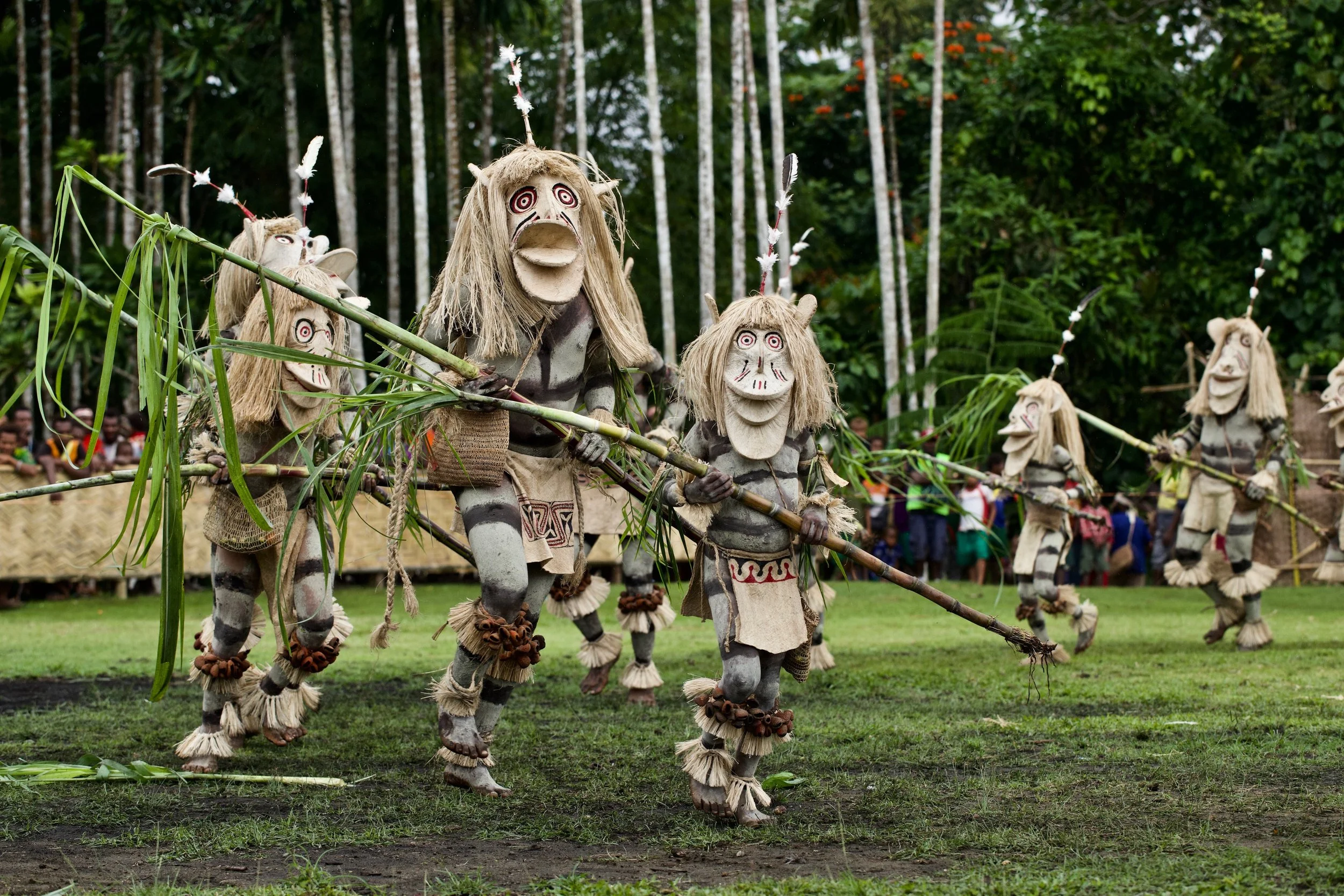 Portraits and candid moments of Papua New Guinea’s diverse cultures, featuring traditional dress, masks, and ceremonial performances.