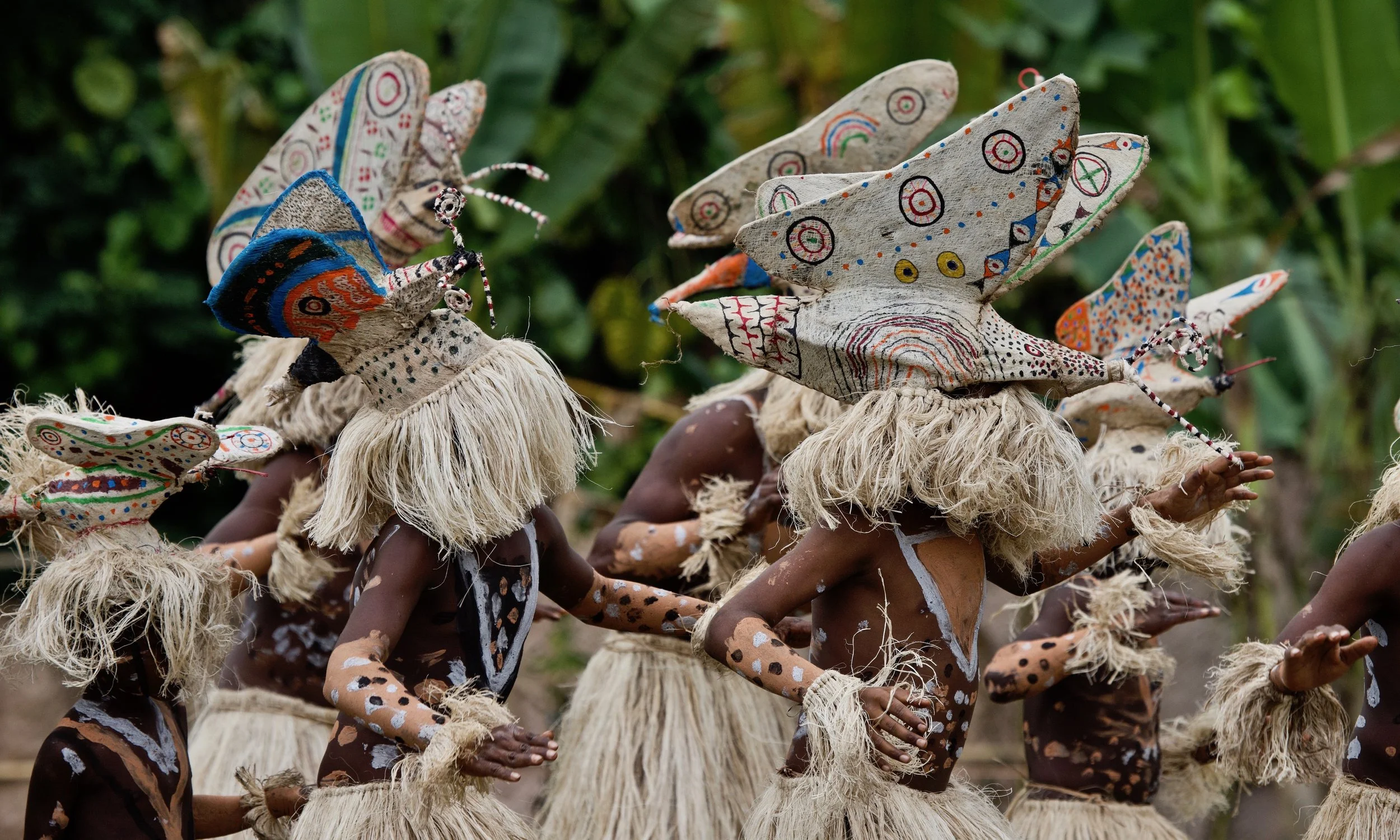 Portraits and candid moments of Papua New Guinea’s diverse cultures, featuring traditional dress, masks, and ceremonial performances.