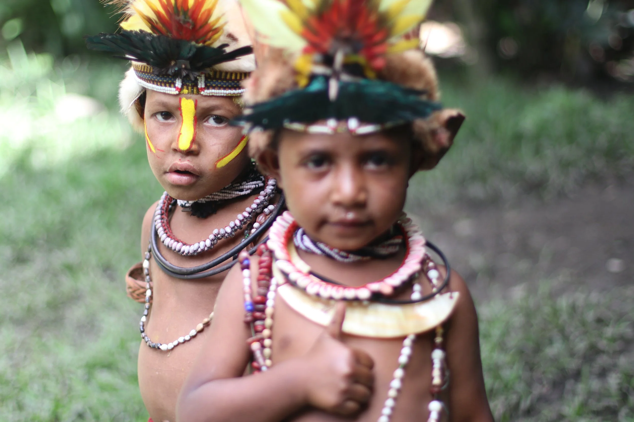 Portraits and candid moments of Papua New Guinea’s diverse cultures, featuring traditional dress, masks, and ceremonial performances.