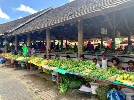 Market stalls featuring an array of fresh brightly coloured produce