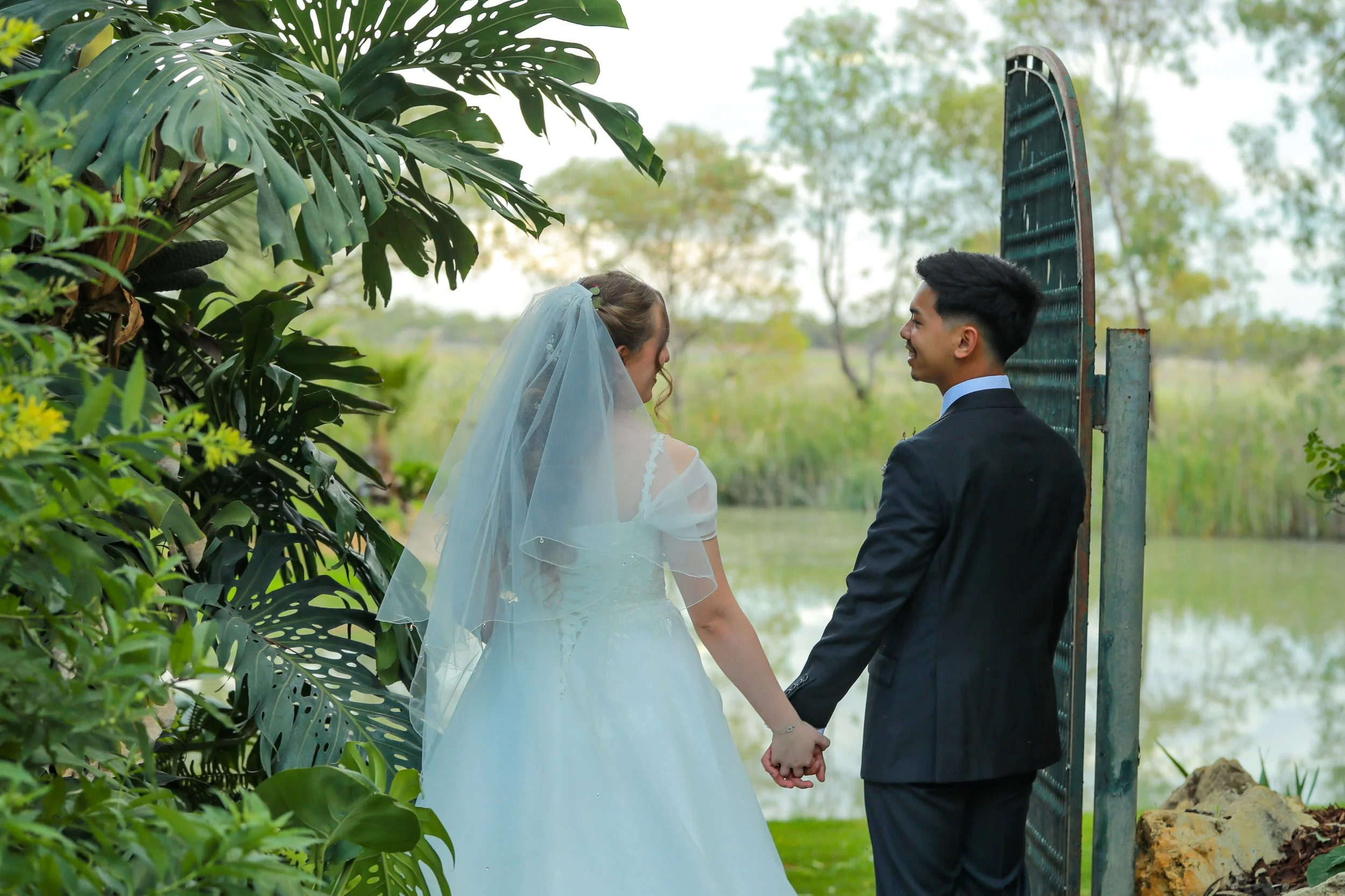 Bride and groom sharing a moment by the water at Greenfield Acres Wedding Venue, one of the unique wedding photography locations across our Riverland property in South Australia.