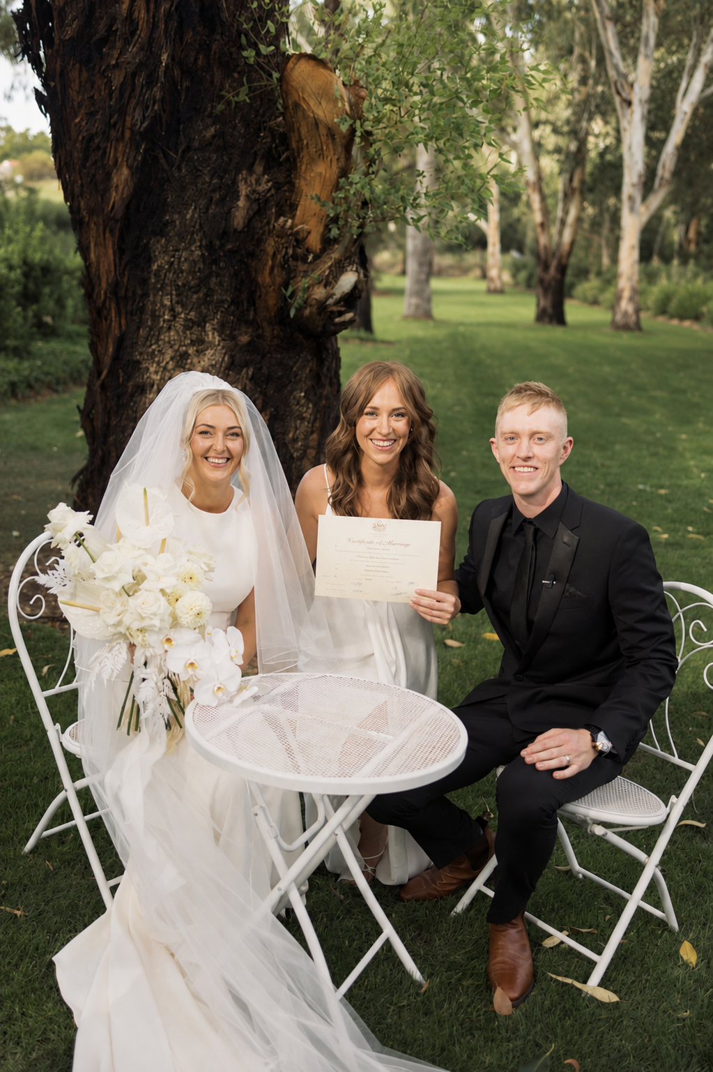 Bride and groom with Chloe Tornow Celebrant signing their marriage certificate at Greenfield Acres Riverland wedding venue.