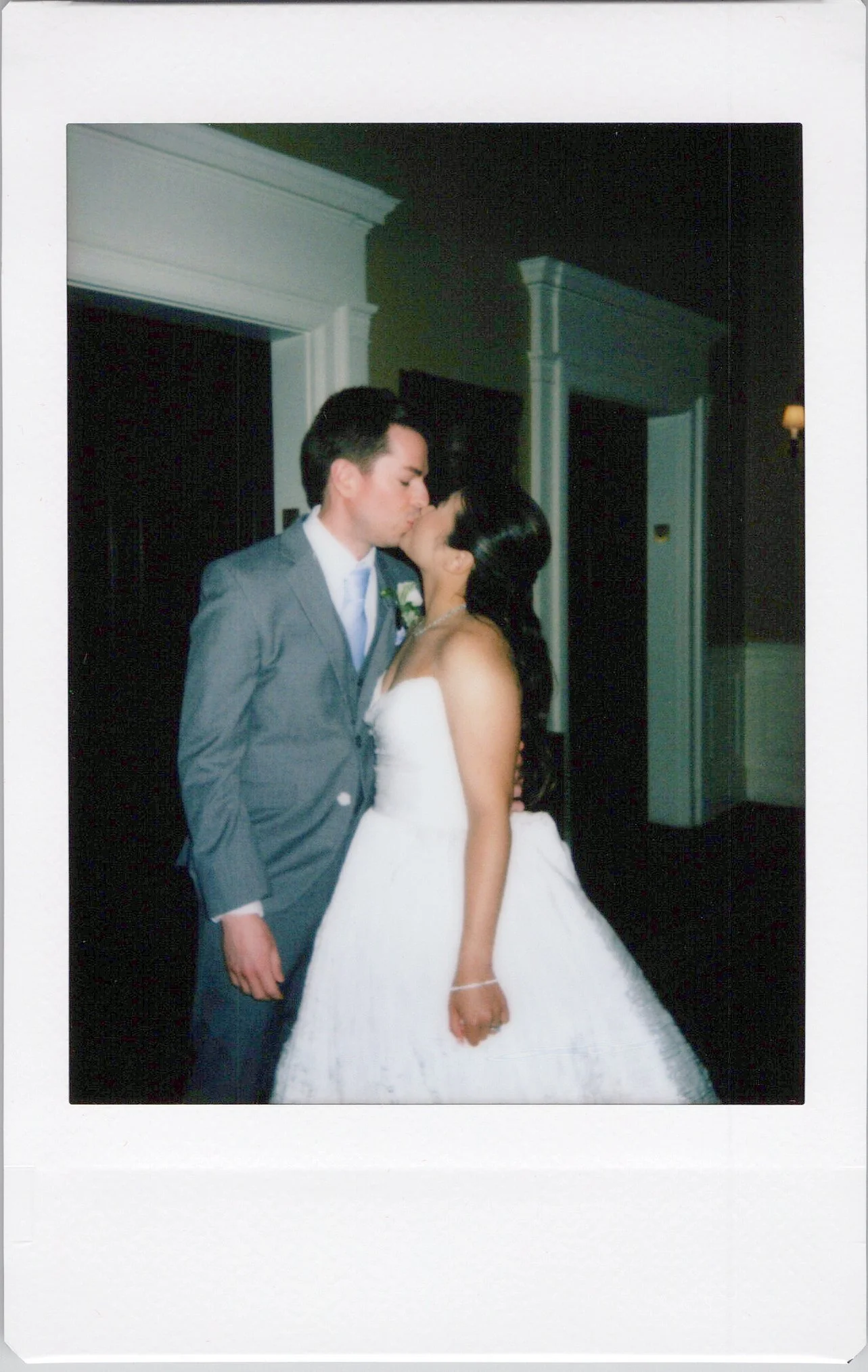 Bride and Groom kiss at cocktail hour in a roaming instant photo
