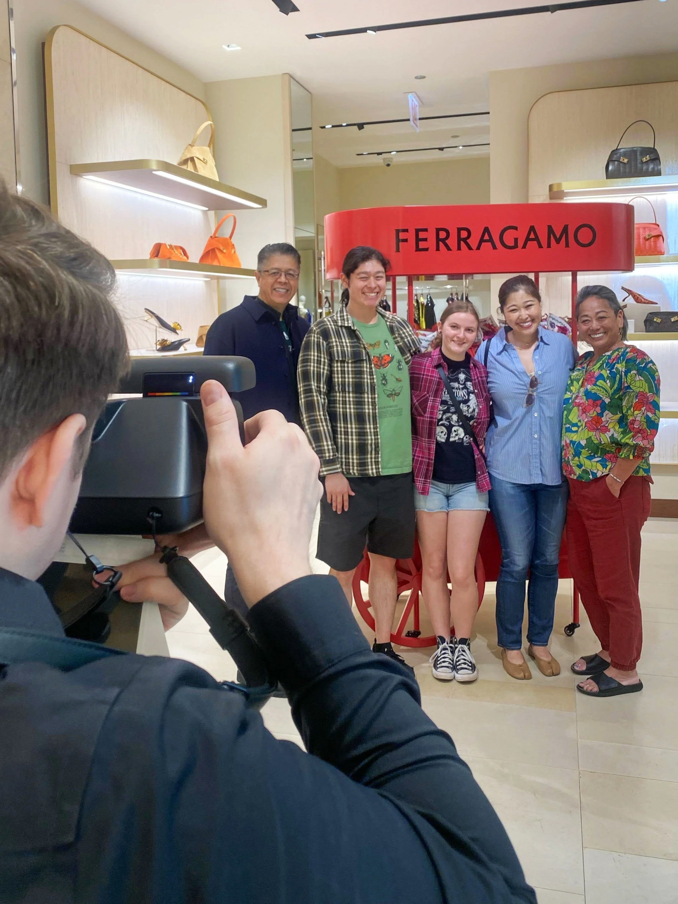 family posing for mothers day polaroid photo brand activation at Ferragamo Michigan Ave, in Chicago