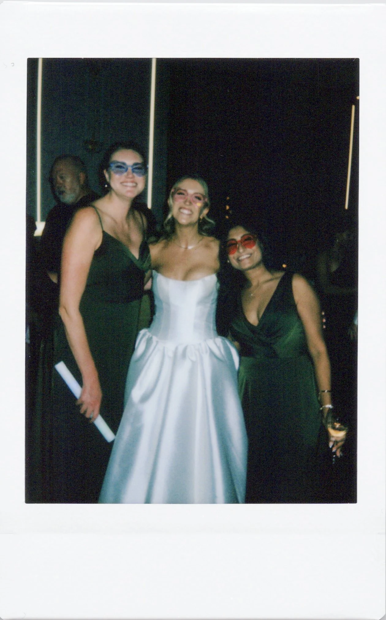 Bride and her friends pose on the dance floor in a wedding polaroid photo in chicago