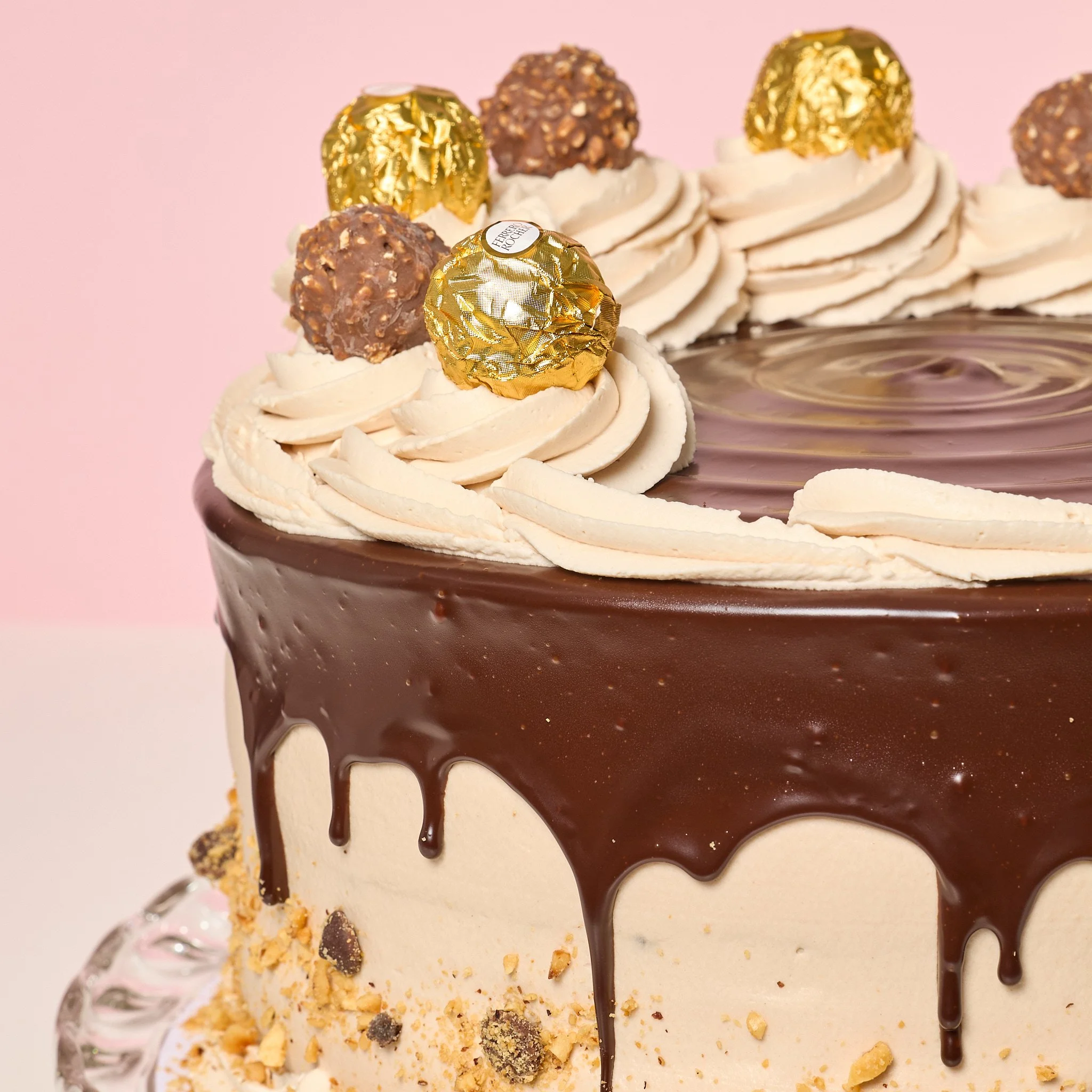 ferrero cake from jennivees bakery in chicago, cake on pink background, onsite event photography mark hawk