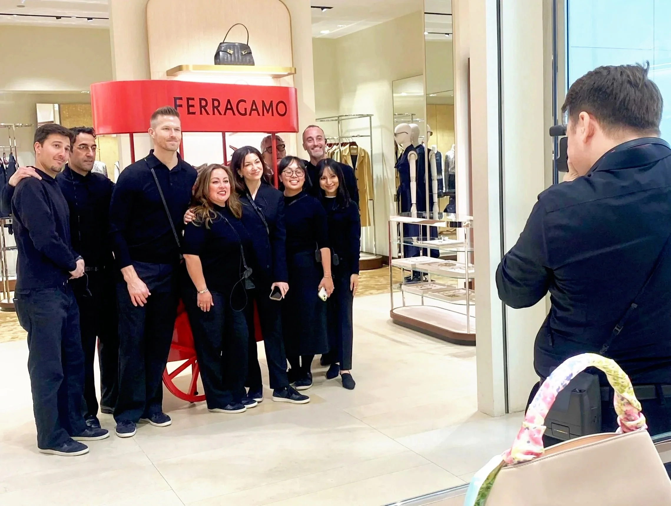 instant onsite photographer taking a photo of a group of people at a ferragamo event in chicago.