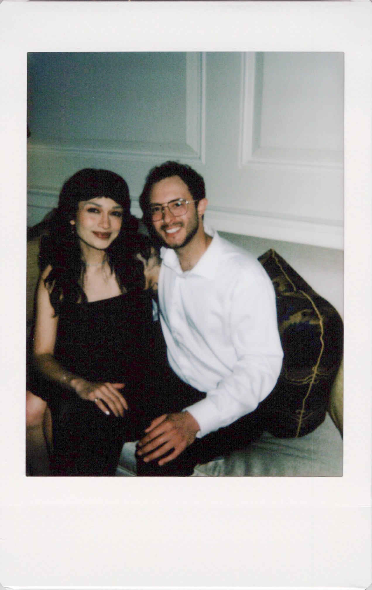 Friends of the couple pose for an instant photo instead of a photo booth at the wedding.