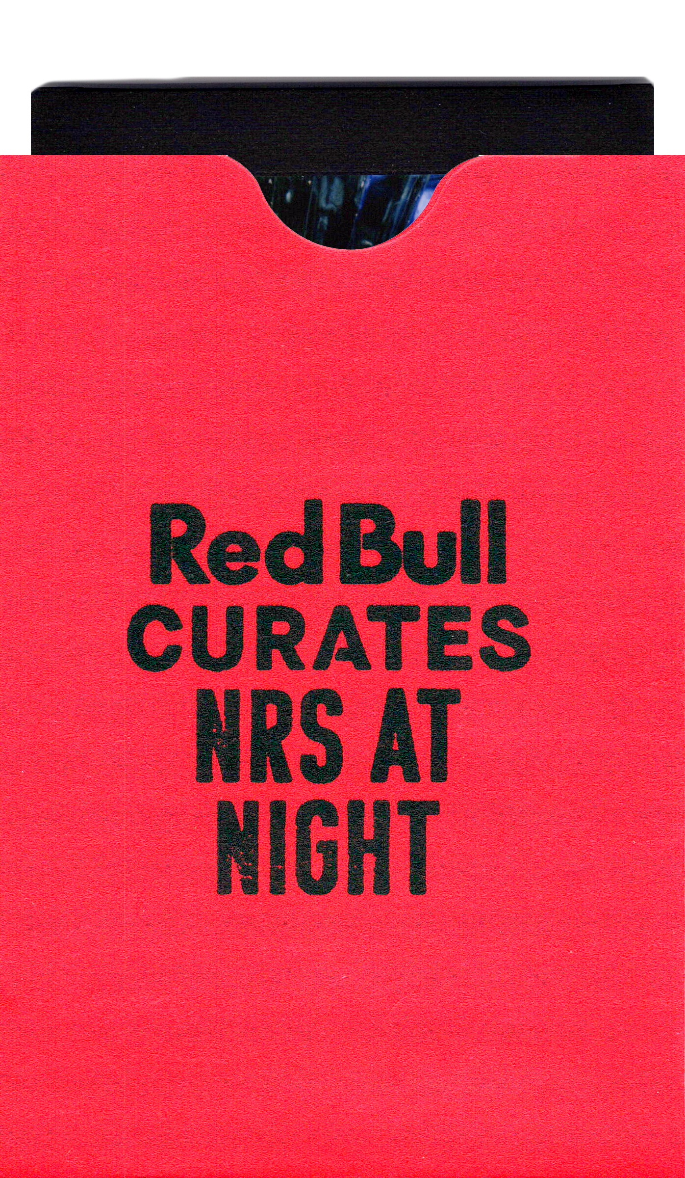 a red sleeve for instax mini photo with a black stamp on it that says "Red Bull CURATES NRS AT NIGHT"