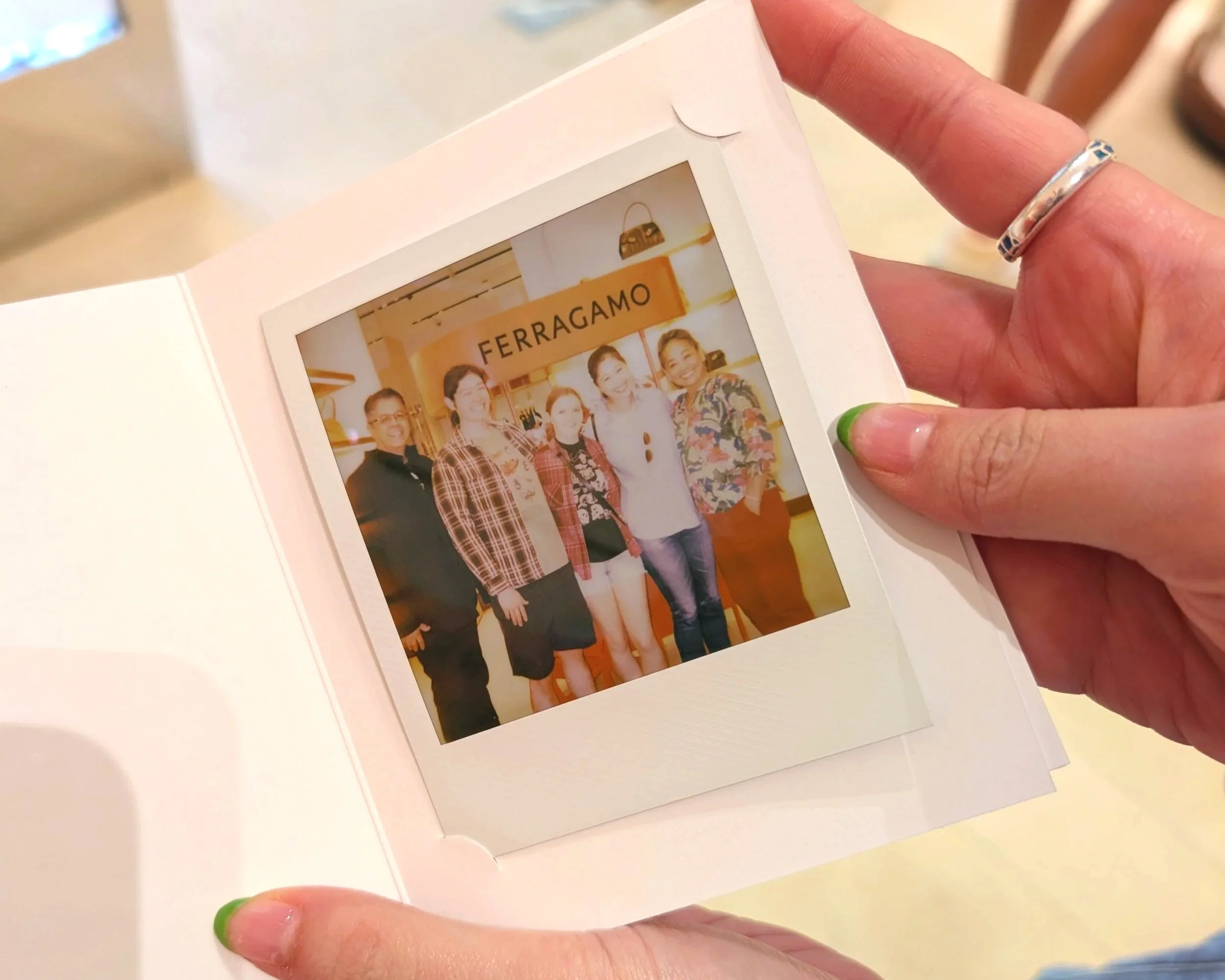 Guest at brand activation holding polaroid photo