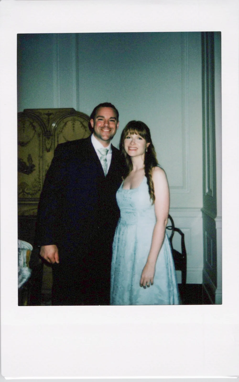 Wedding guests holding an instant photograph