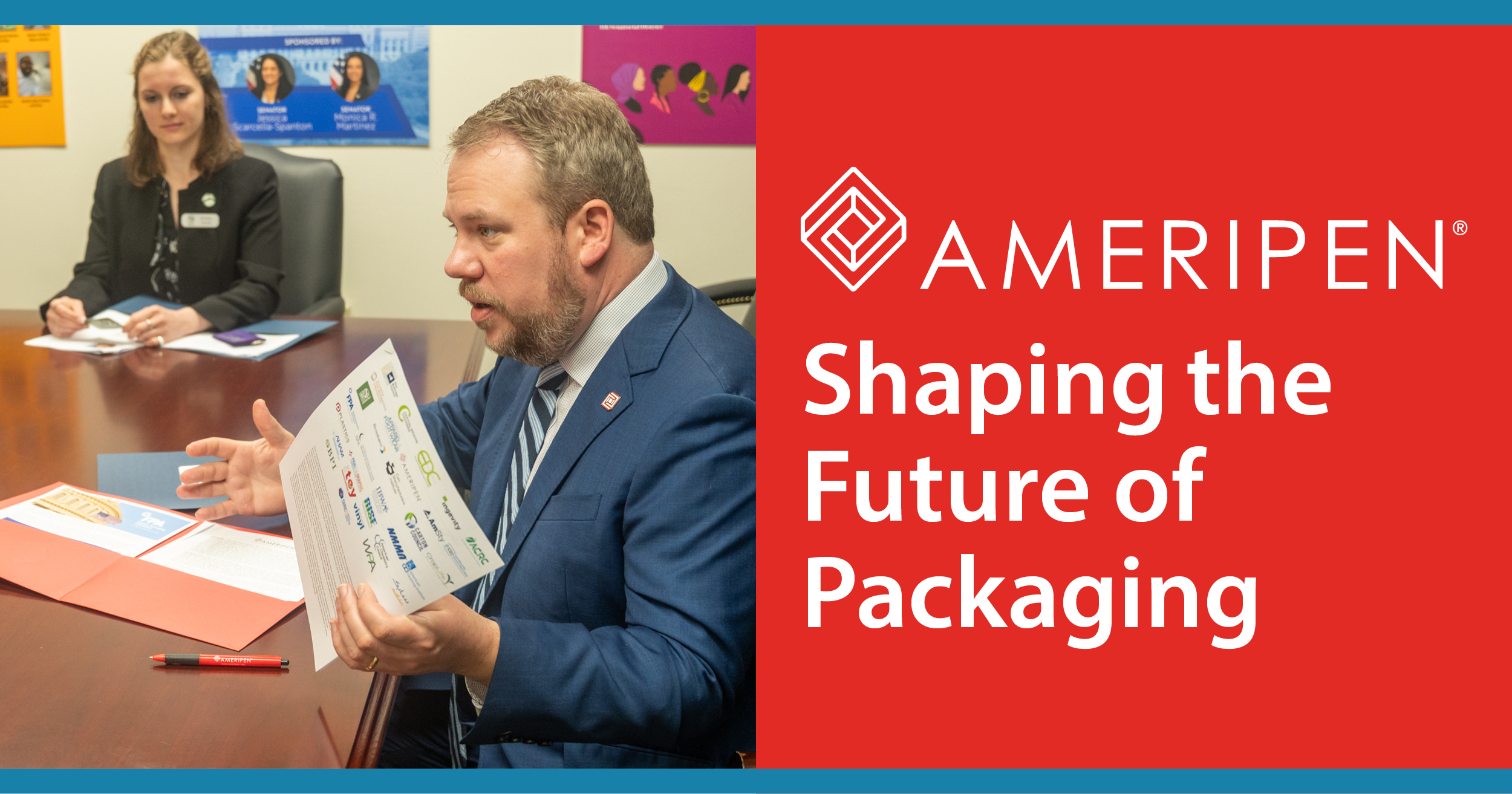 A man in a blue suit and striped tie is sitting at a conference table, reading a brochure, with a woman in a black blazer sitting behind him. The table has documents, a red pen, and folders. The background has political campaign posters and colorful artwork. The right half of the image contains a red background with the AmRePen logo and the text 'Shaping the Future of Packaging'.