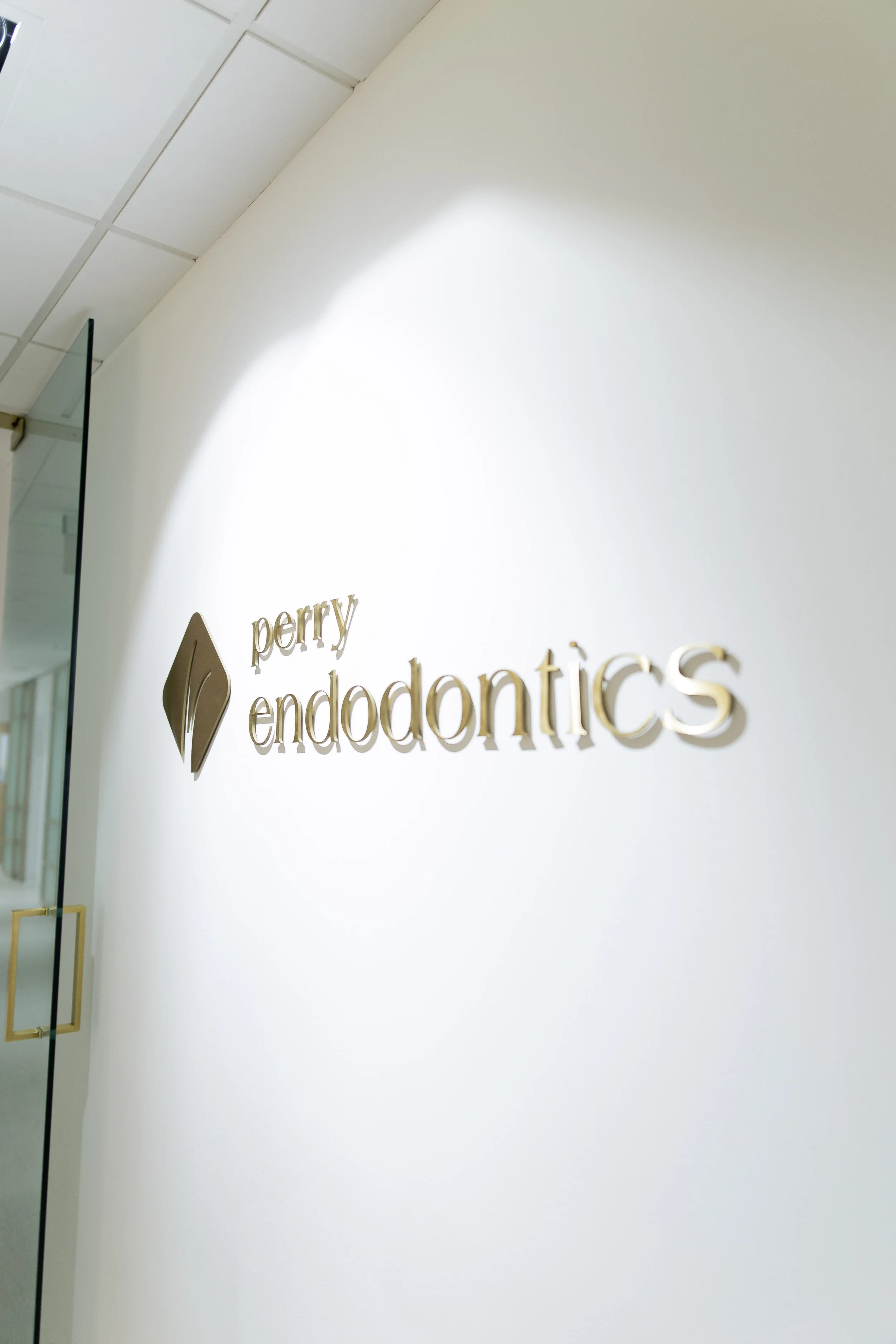 Perry Endodontics office sign on a white wall.