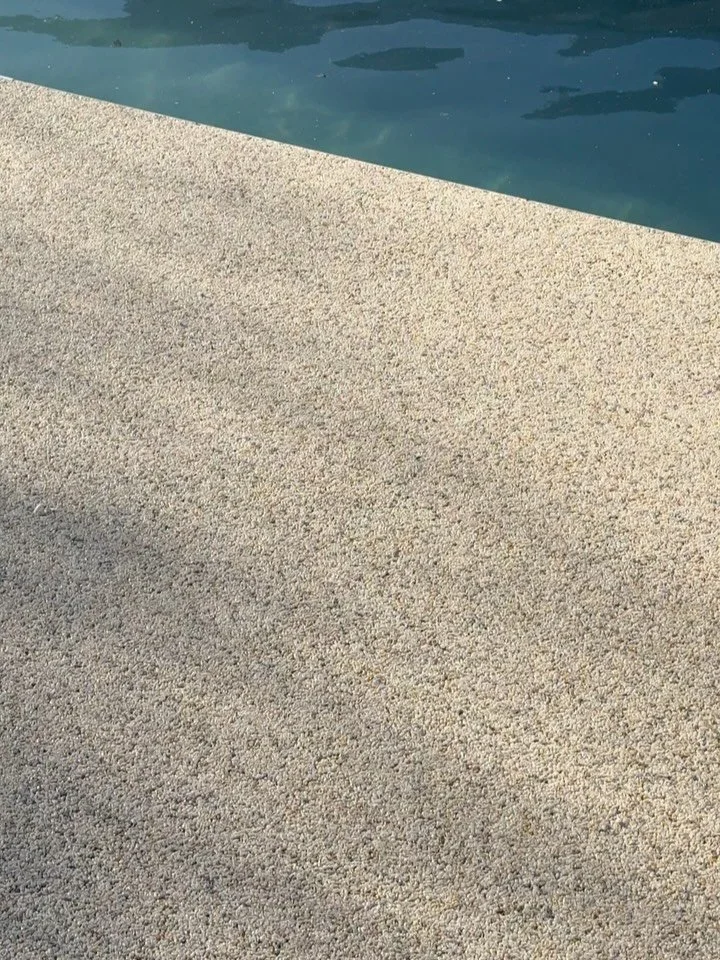 Vuba resin down around the pool - anti-slip, permeable, durable and UV resistant and a seamless finish!