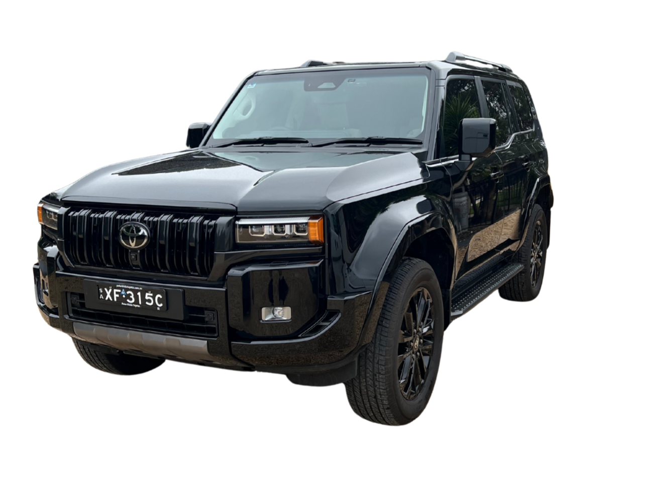 Black Toyota SUV with Australian license plate XF 315C, front view, isolated on black background.