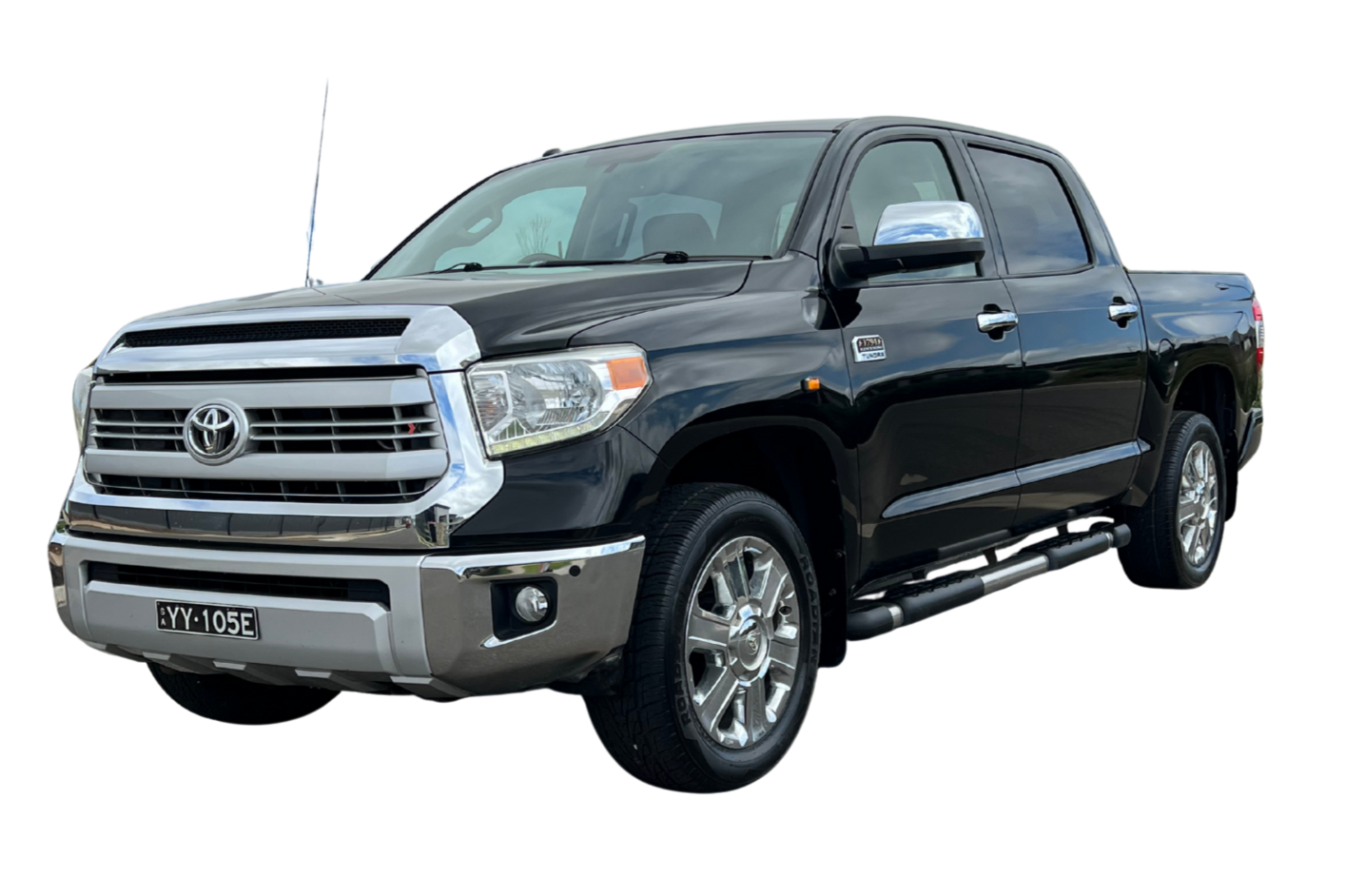 A black Toyota Tundra pickup truck with chrome accents, four doors, and a chrome front grille.