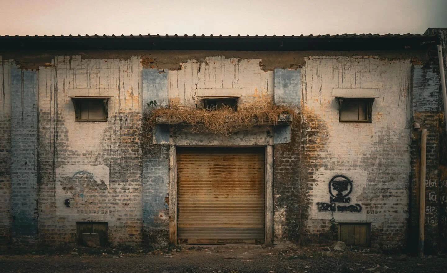 Unaccounted For 

This photograph documents an abandoned building in my village in India, a structure whose original function is now unknown. 

Left unused and gradually weathered by time, the building exists in a state of suspension, neither fully p