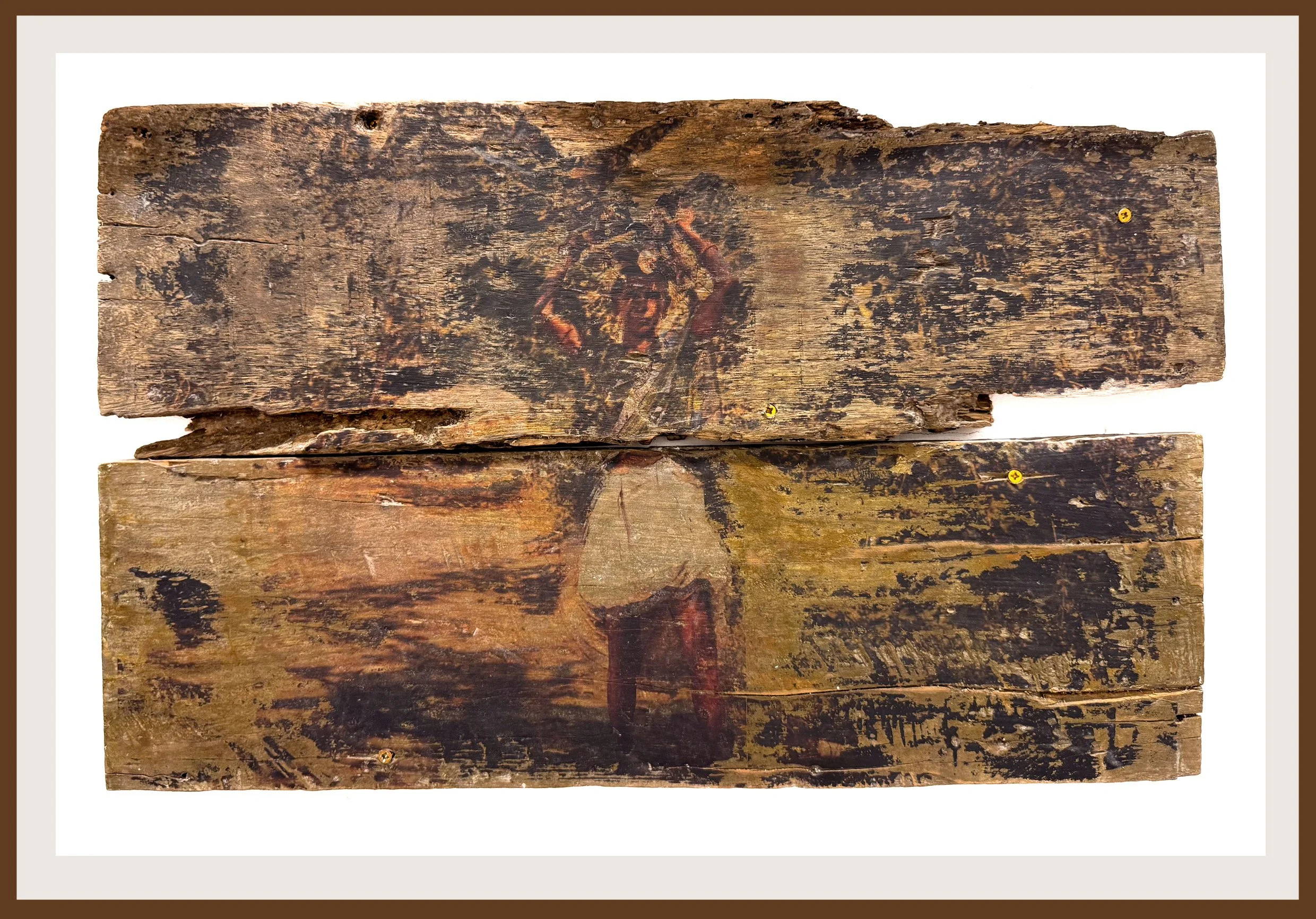 Close-up of old, weathered wooden planks with an image of a woman holding wooden sticks above her head.