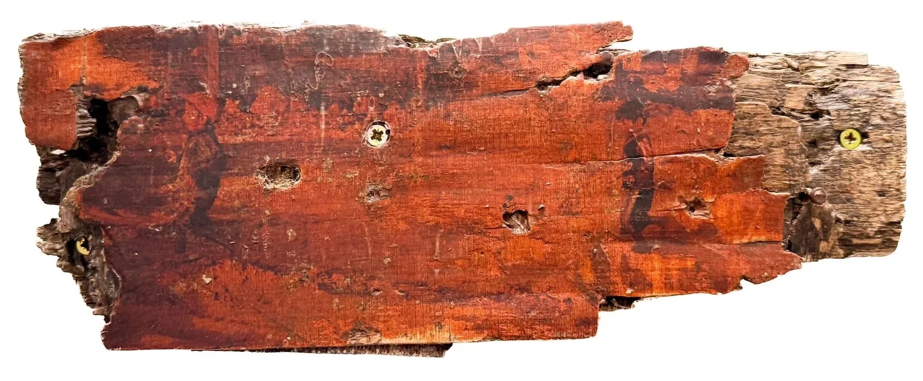 A weathered, aged wooden piece with a reddish-brown hue, showing multiple holes, cracks, and rusty screws. Image of two boys printed on top.