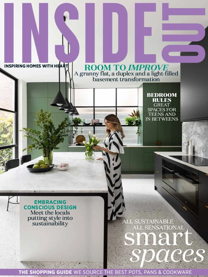 Cover of Inside Out magazine featuring a modern kitchen with a woman in a black and white dress arranging flowers on a white kitchen island. Green cabinetry, black pendant lights, and large windows are visible. Text highlights include "Room to Improve," "Embracing Conscious Design," and "Smart Spaces."