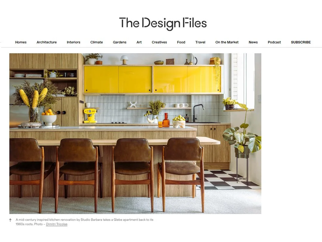 Modern kitchen with a wooden island, brown leather chairs, yellow cabinets, and a black-and-white checkered floor pattern.