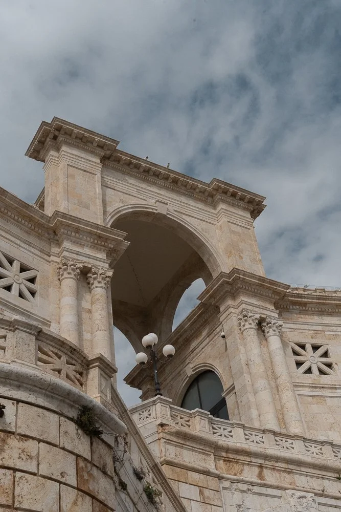 Bastione Saint Remy in Cagliari is a majestic light-stone building that leads to a terrace. Terrazza Umberto I.