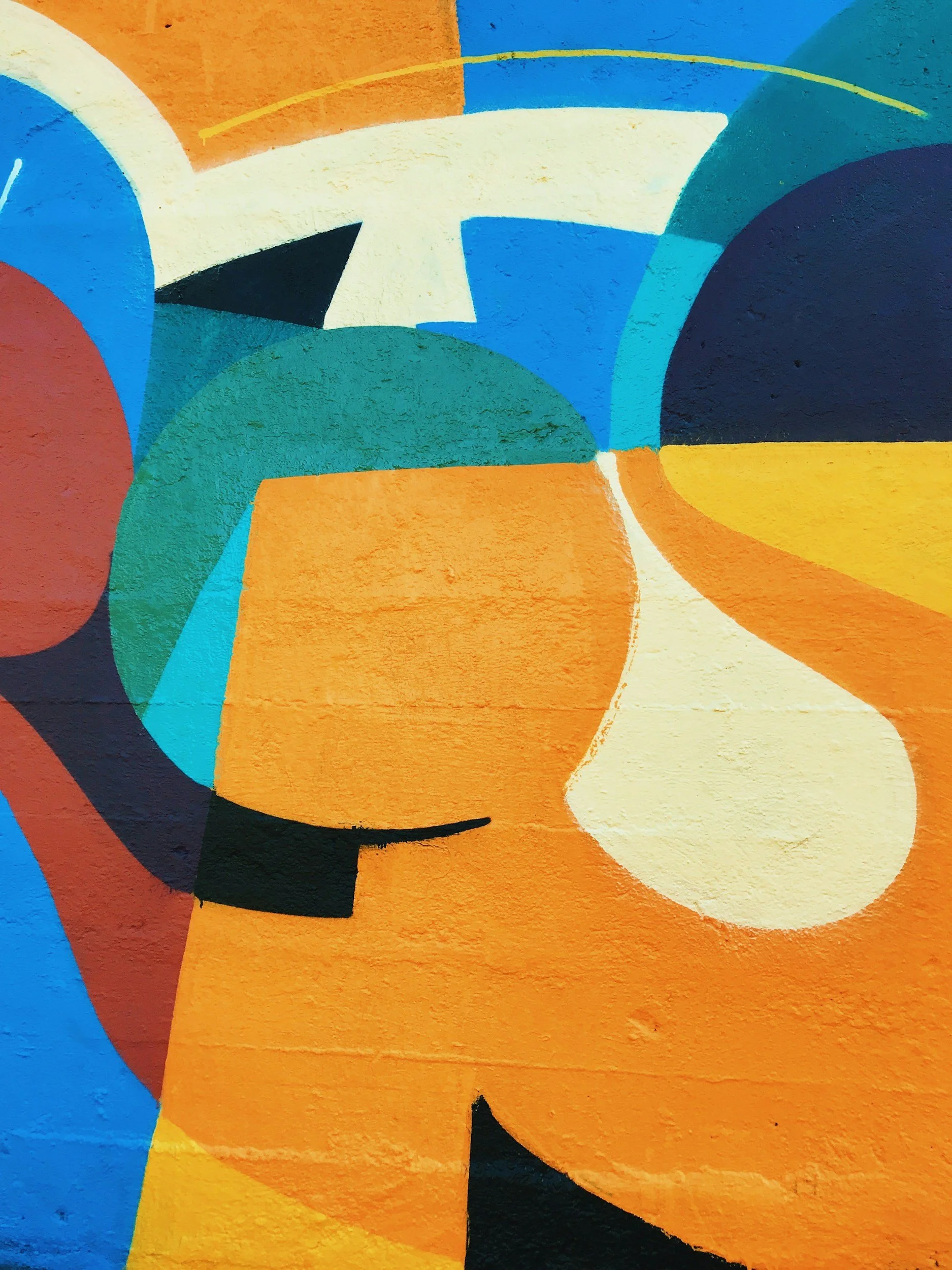 Abstract colorful mural with shapes in blue, orange, yellow, black, and white.