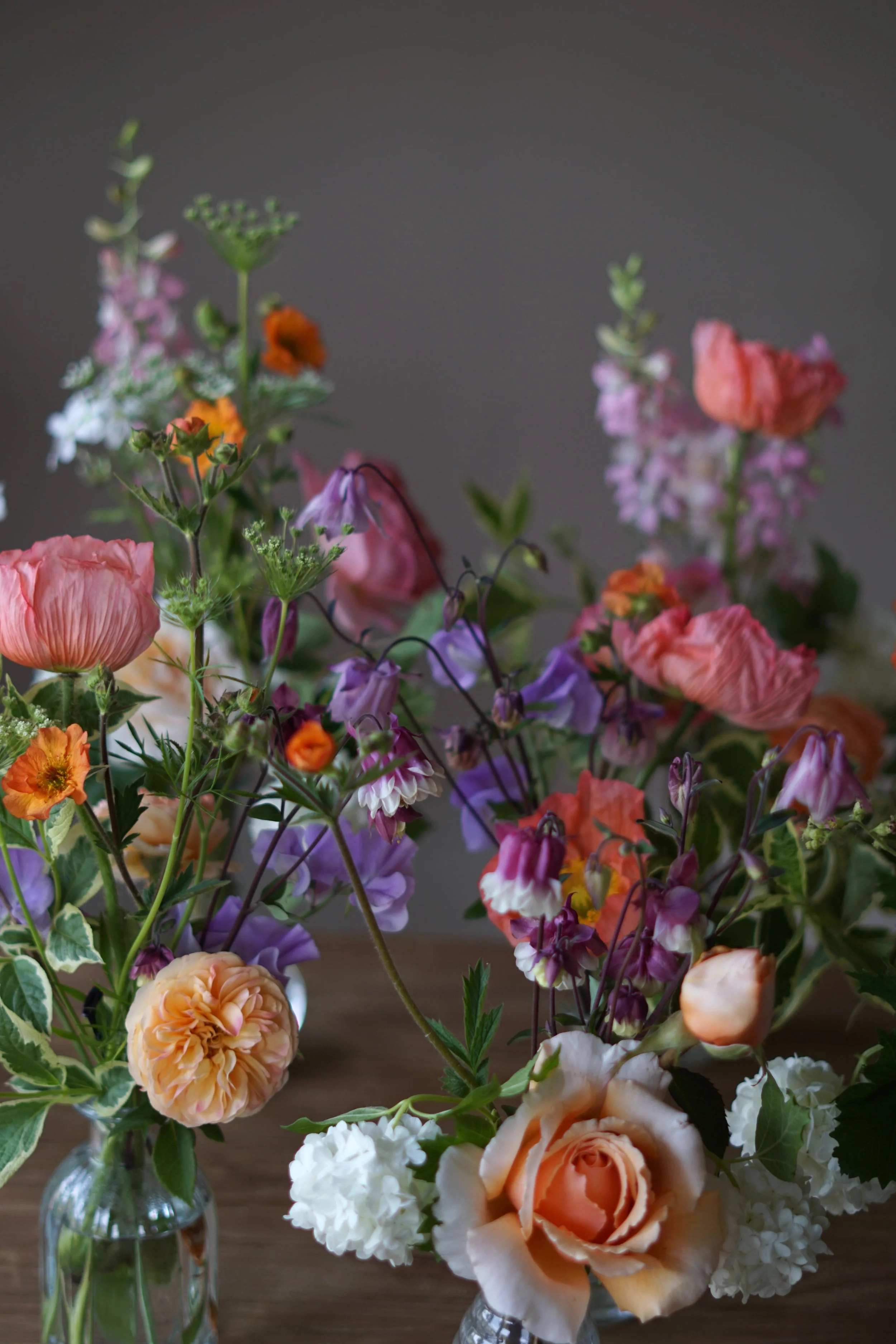 british flower wedding flowers in coral, peach, orange and purple