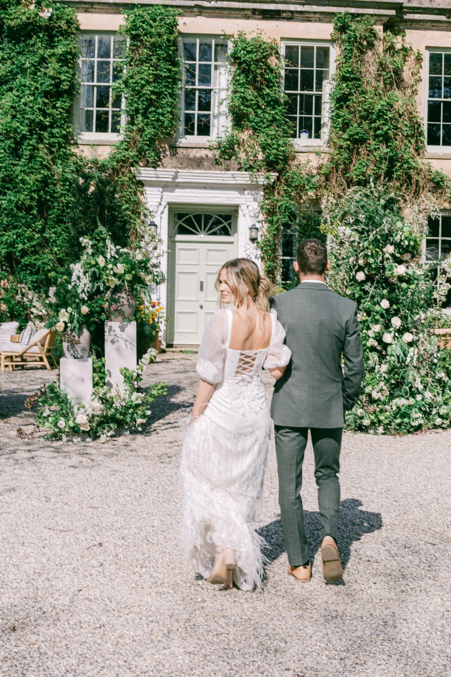 bride and groom outside The Lost Music Hall wedding venue with spring ceremony flowers